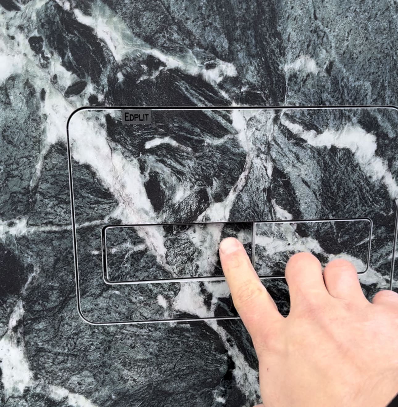 Person gently pressing tile to activate Edplit Invisi Tile Touch M2 hidden flush design