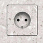 Invisible socket outlet for tiled walls seamlessly integrated into a stone-effect tile surface